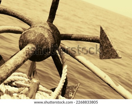 An old rusted anchor shot from a moving boat