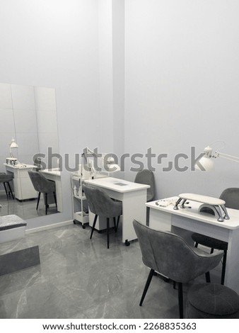 Nail salon bright interior. View of modern manicure shop. Inside beauty studio with white design. Clean empty trendy nail salon.