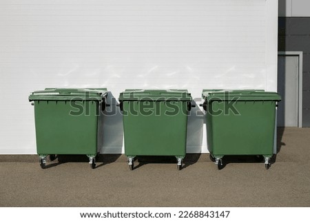 Three green dumpsters on the street. Garbage bin Royalty-Free Stock Photo #2268843147