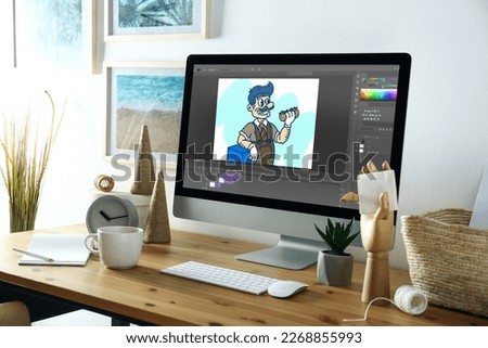 Animator's workplace. Modern computer with illustration on screen