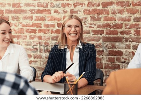 Businesswoman having meeting with her employees in office. Lady boss