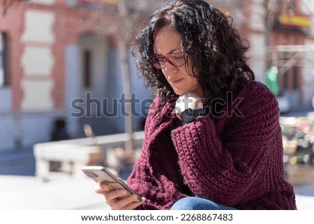 Woman chatting with her smartphone