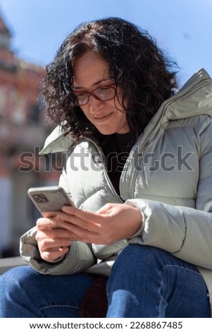 Woman chatting with her smartphone