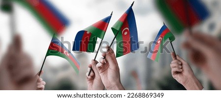 A group of people holding small flags of the Azerbaijan in their hands. Royalty-Free Stock Photo #2268869349