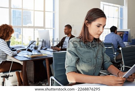 Woman, reading tablet and focus in office at web design startup with ideas, planning and job schedule. Tech vision, gen z developer and coworking for app ux, website and mobile touchscreen at desk Royalty-Free Stock Photo #2268876295