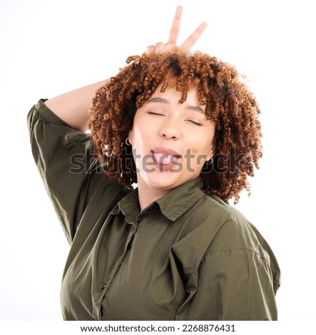 Black woman, peace sign and funny expression with smile, tongue out and cheerful girl isolated on white studio background. Jamaican female, lady and silly face for fun, finger and playful with joy