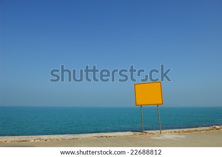 Blank sign against beautiful blue ocean.