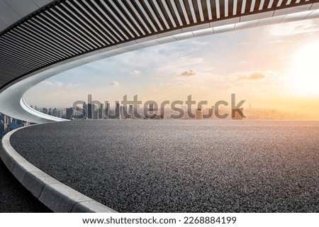 Asphalt road platform and Bridge with the city skyline at sunset in Shanghai, China.