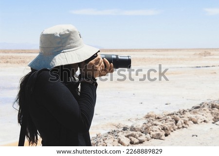 woman taking a photograph camera zoom lens atacama desert tour