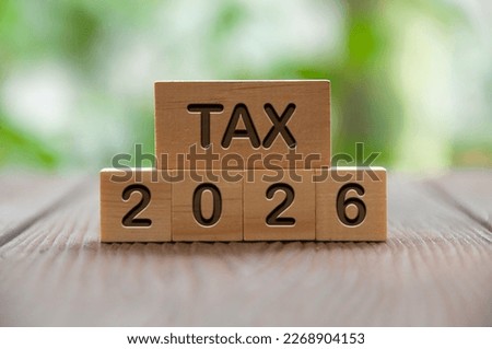 Tax 2026 text on wooded blocks with blurred nature background. Taxation and filing concept. Royalty-Free Stock Photo #2268904153