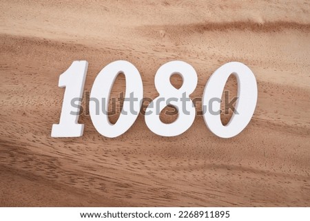 White number 1080 on a brown and light brown wooden background.