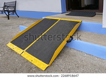 Portable foldable Wheelchair Ramp to the front of a building 