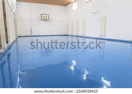Self leveling blue epoxy floor in the gym Royalty-Free Stock Photo #2268928425