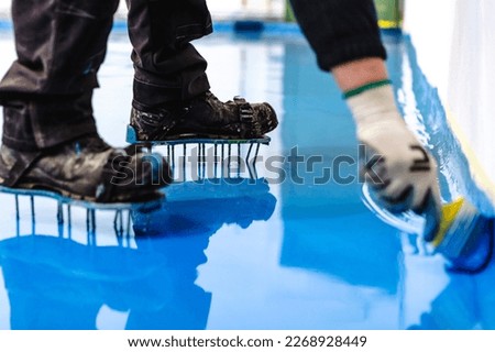 Self leveling blue epoxy floor in the gym Royalty-Free Stock Photo #2268928449