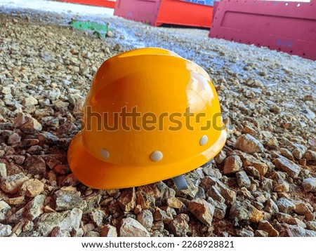 corporate project yellow helmet on the gravel Royalty-Free Stock Photo #2268928821