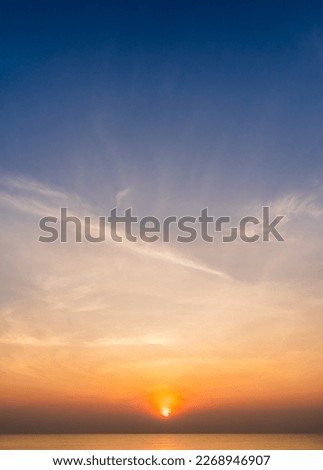 Sunset Sky clouds vertical over sea in the morning with orange sunrise on dark blue sky, Dusk Royalty-Free Stock Photo #2268946907