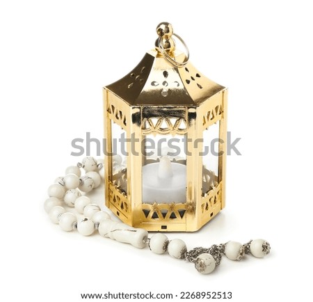 Muslim lantern with candle and prayer beads for Ramadan on white background Royalty-Free Stock Photo #2268952513