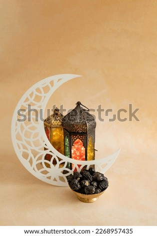 Ramadan Kareem 2024 background, Colourful lantern lamp with crescent moon shape and dates in a golden colour bowl  Royalty-Free Stock Photo #2268957435