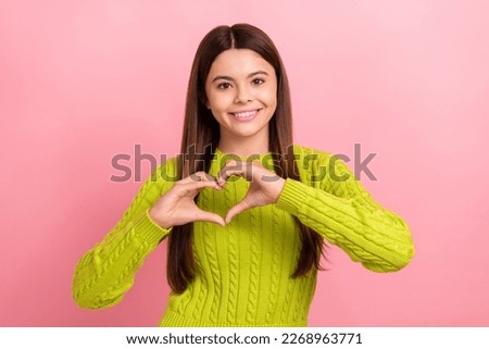 Photo portrait of lovely teen lady arms heart shape positive feedback dressed stylish green garment isolated on pink color background
