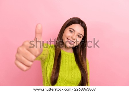 Photo portrait of lovely teen lady showing thumb up good quality dressed stylish green clothes isolated on pink color background