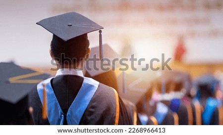 Rear view of university graduates wearing graduation gown and cap in the commencement day Royalty-Free Stock Photo #2268966413