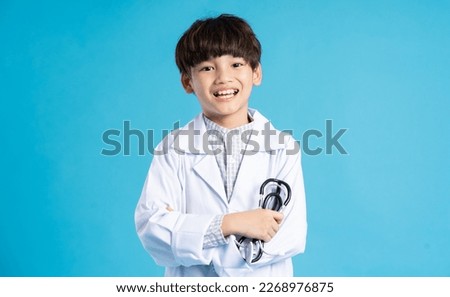 Asian boy portrait posing on blue background