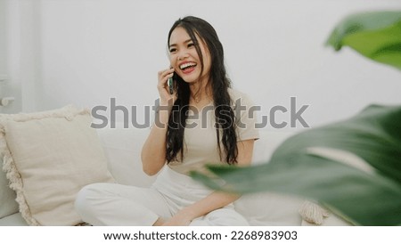 Young woman using smartphone at home.