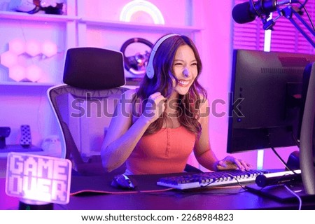 Young Asian Pretty woman Pro Gamer have live streaming , singing  and chatting  with her fans  at home