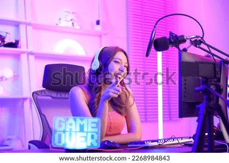 Young Asian Pretty woman Pro Gamer have live streaming , singing  and chatting  with her fans  at home Royalty-Free Stock Photo #2268984843