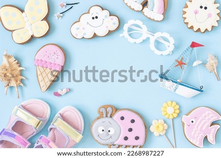 Bright creative layout made of cute summer symbols with copy space on blue background. Top view, Flat lay. Creative summer concept.