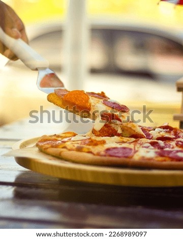 delicious pepperoni pizza dipped in cheese, pizza restaurant. warm light to crave
