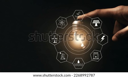 Light bulb on a dark background. Glowing light bulb with energy resources icon. The concept of saving electricity and energy. environmentally friendly and sustainable