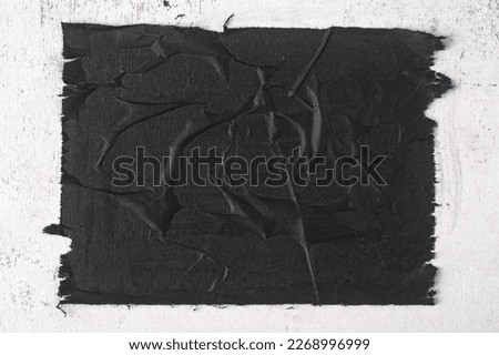 Close-up of a sheet of black paper with folds. Royalty-Free Stock Photo #2268996999