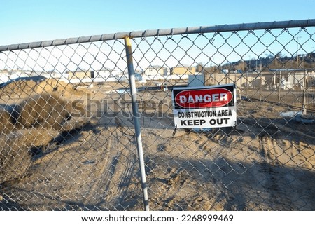 Danger sign on chain linked fence for construction area