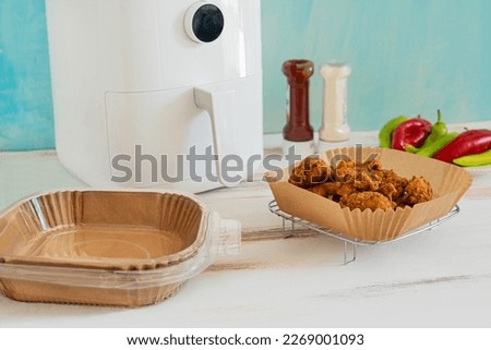 Healthy food from the fryer. Disposable greaseproof paper without contaminating the fryer. Royalty-Free Stock Photo #2269001093
