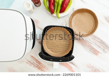 Healthy food from the fryer. Disposable greaseproof paper without contaminating the fryer. Royalty-Free Stock Photo #2269001101