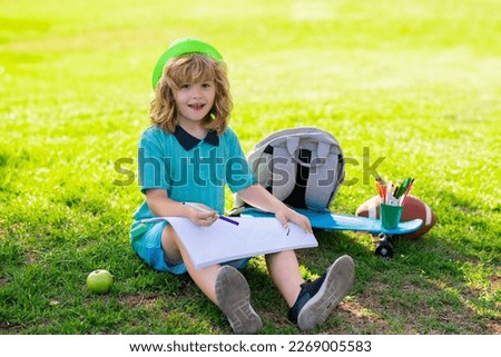 School kids drawing in summer park, painting art. Little painter draw pictures outdoor.