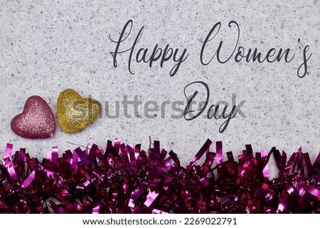 pink tinsel with yellow and pink hearts with happy women's day 