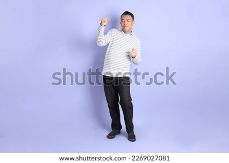 The 40s adult Asian man with standing on the purple background.