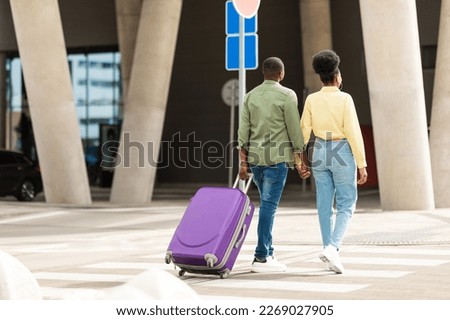 Rear View Of Black Family Couple Walking With Travel Suitcase At Modern Airport Terminal Outdoors. Full Length Shot Of Unrecognizable Tourists Traveling On Vacation Together Royalty-Free Stock Photo #2269027905