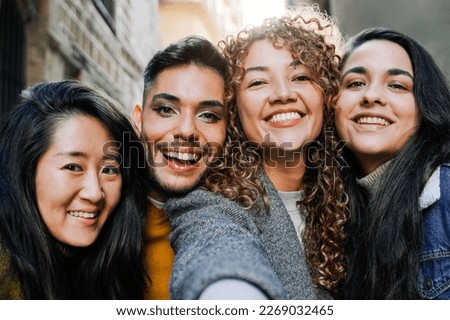 Diverse group of friends having fun taking selfie outdoors - Focus on gay transgender man wearing makeup - Travel holidays concept