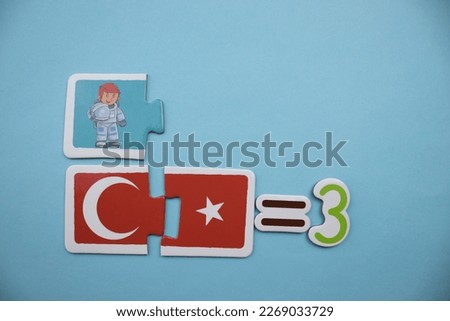 Crescent and star puzzle with red and white colors, astronaut picture puzzle and equals three text placed on blue background.