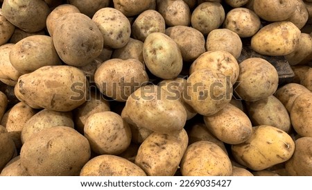 Pile of fresh potatoes on sale in vegetable stand display at supermarket show organic food, vegetarian food, Healthy food. Heap of potato sale in market use for texture and background.