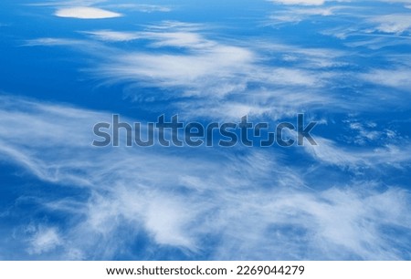 White clouds in the blue sky. Beautiful background for photo wallpapers.
