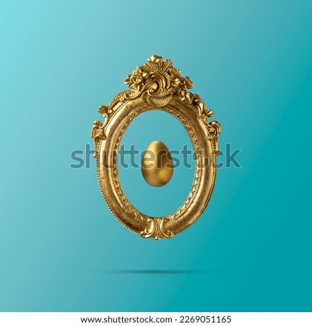 Golden egg in old golden vintage frame. Minimal elegant Easter composition