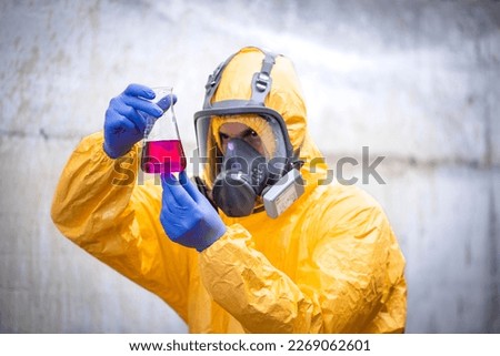 Chemical testing laboratory. Worker in special equipment and gas mask testing quality. Royalty-Free Stock Photo #2269062601