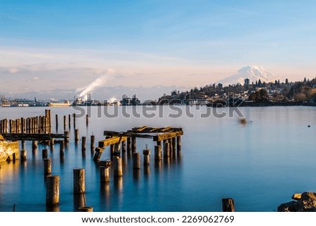 Long Exposure shot of old pier pilings with Mount Rainier in the background. Tacoma water front.