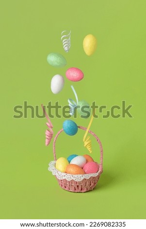 Beautiful flying Easter eggs on light green background.