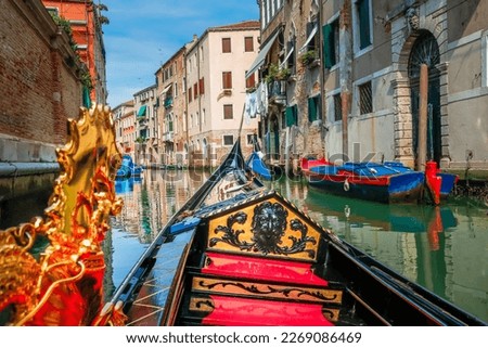 Ornate Gondola in peaceful Canal corner at springtime sunny day, Venice, Italy