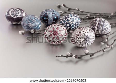 Handmade Easter eggs on a silver background with willow twigs Royalty-Free Stock Photo #2269090503